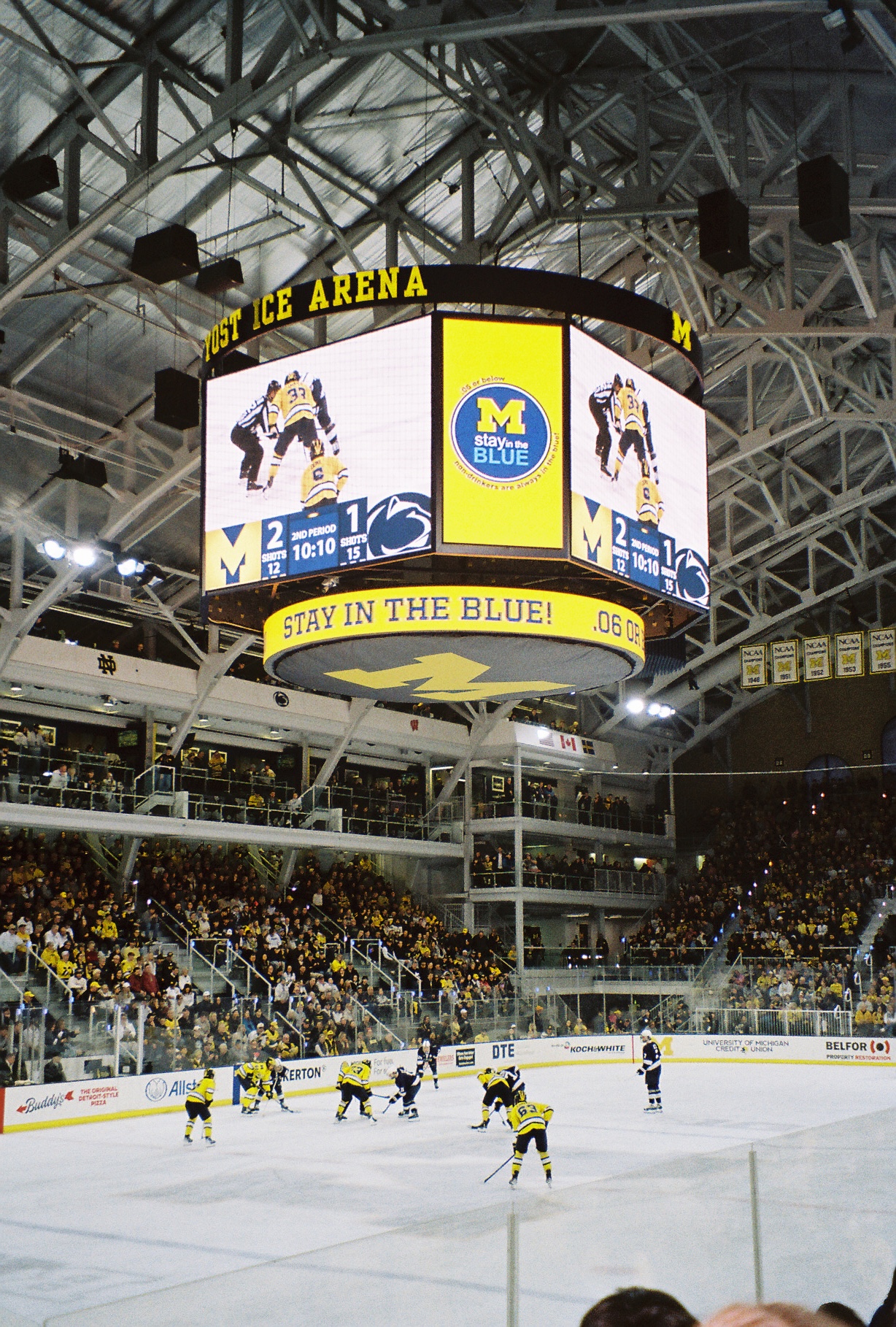 Michigan hockey arena scoreboard hanging from the ceiling mid-game mid game